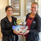 Team member holding gift basket