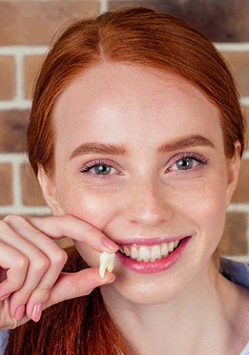 young woman smiling after tooth extraction in Daniel Island