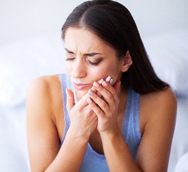 young woman with hurting tooth