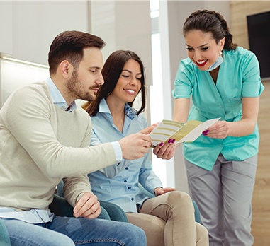 Dental team member helping patients with dental insurance claims