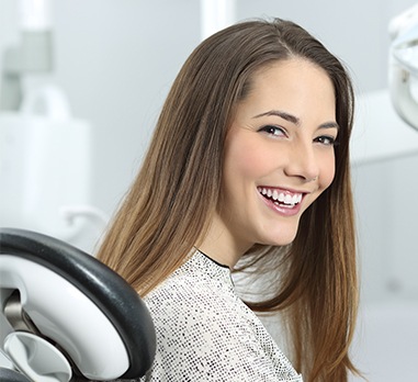 Woman in dental chair smiling