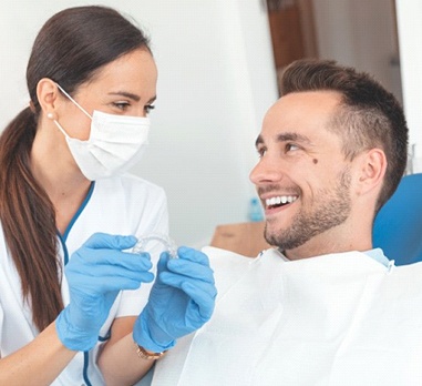 dentist showing Invisalign to a patient