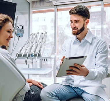 dentist showing a tablet to a patient