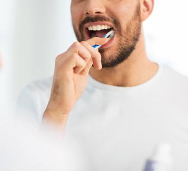 brushing teeth for dental implant care in Daniel Island