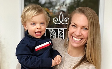 Dentist holding a smile child and smiling