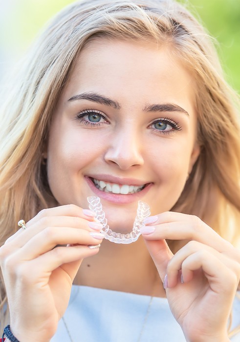 Woman placing a clear aligner tray