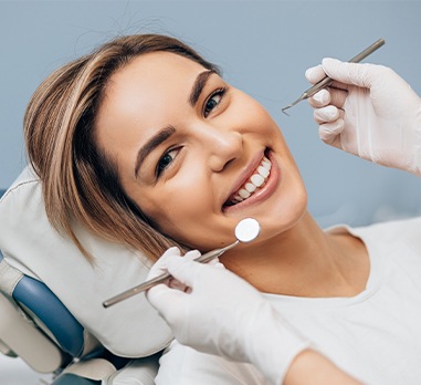 Woman smiling during dental checkup and teeth cleaning visit