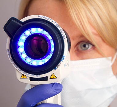 Dentist performing oral cancer screening