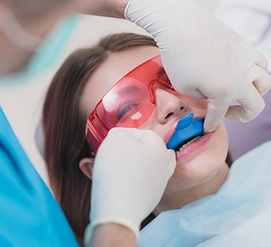 Young woman receiving fluoride treatment