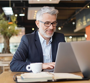 Man scheduling a dental appointment online using his laptop