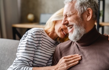 Man and woman with healthy smiles after preventive dentistry