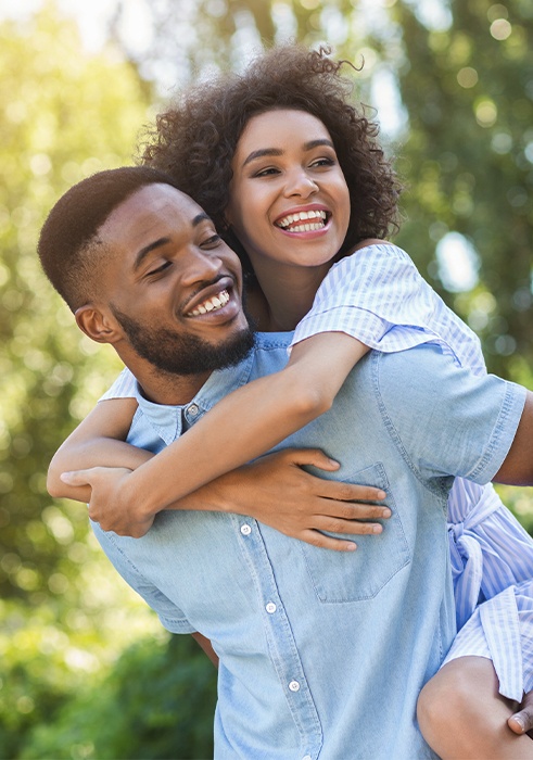 Man and woman smiling after dental visit