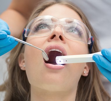 Dentist using intraoral camera to capture smile photos