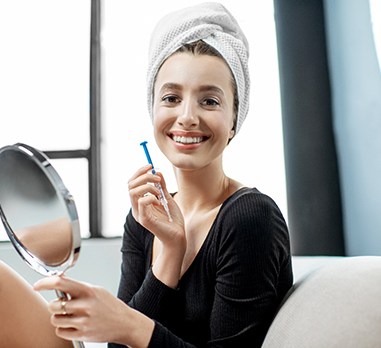 Woman using take-home whitening in Daniel Island