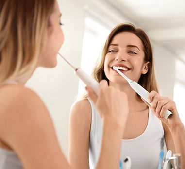 Woman brushing teeth in Daniel Island