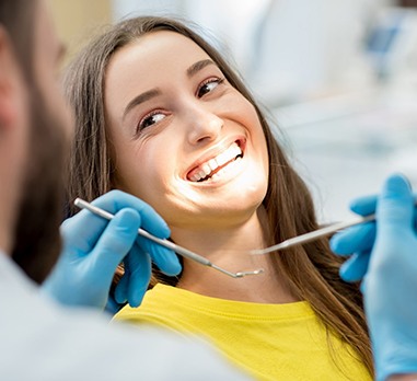 Woman smiling at cosmetic dentist in Daniel Island during teeth whitening consultation